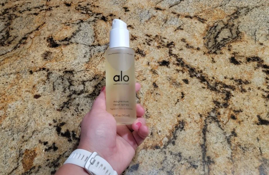 hand holding alo yoga magnesium reset spray