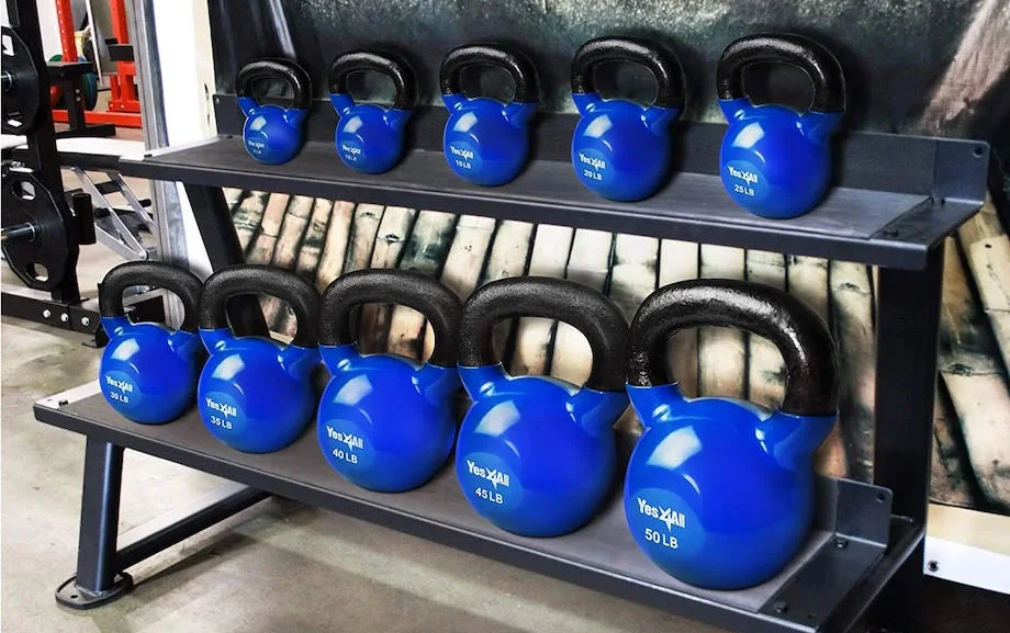 A storage rack with various sizes of Yes4All Vinyl Coated Kettlebells