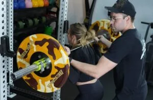 Female back squat with spotter