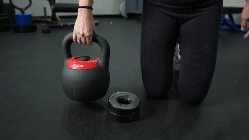 Our tester adjusting the weights of the REP Fitness Adjustable Kettlebell