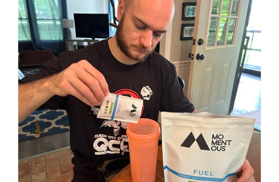Man pouring Momentus Fuel into a shaker cup