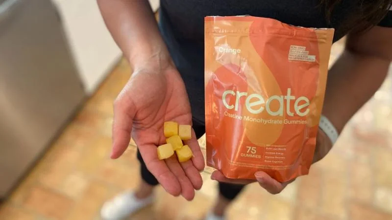 Our product tester holding Create Creatine Gummies in their hand