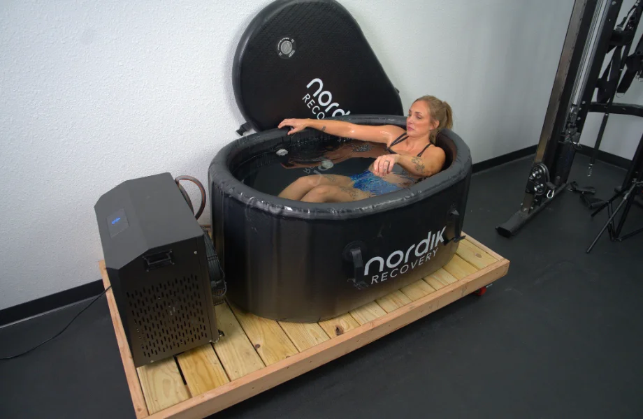 Our tester nestling into the Nordik Recovery Cold Tub for a plunge session