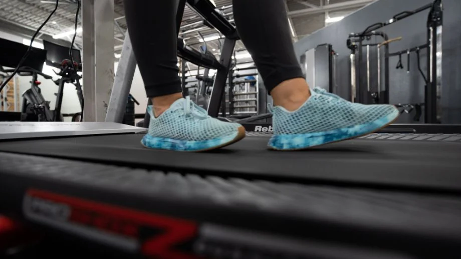 up close feet walking backward on treadmill