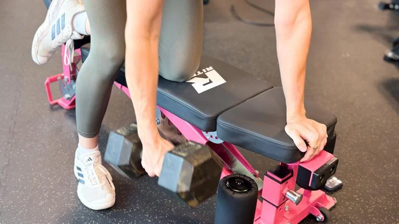 A person lifting weights on Ritfit Gator Bench.