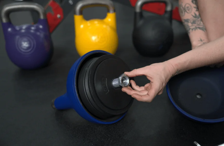 Our tester locking the weight plates into place in the Bells of Steel Adjustable Competition Style Kettlebell