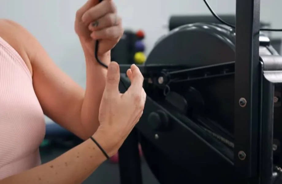 A person adjusting the wires on the myrow monitor