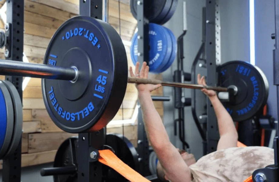Coop bench pressing with Bells of Steel Dead Bounce Bumper Plates