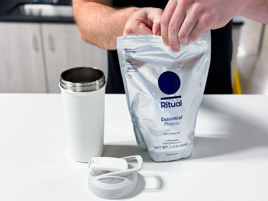 Opening a bag of Ritual Essential Protein Daily Shake 18+