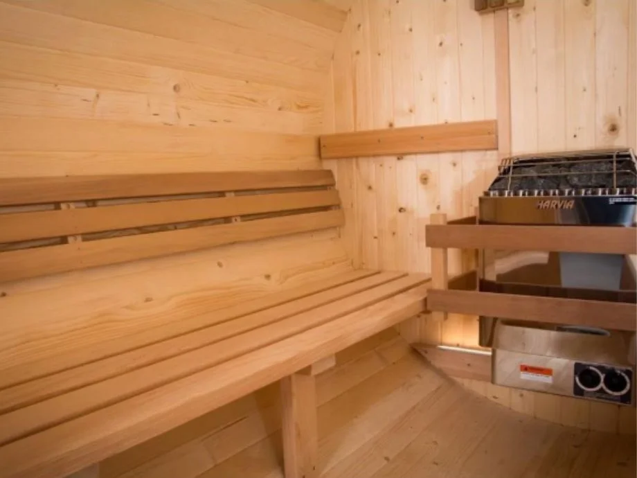 Bench and heater inside the Almost Heaven Morgan Barrel Sauna