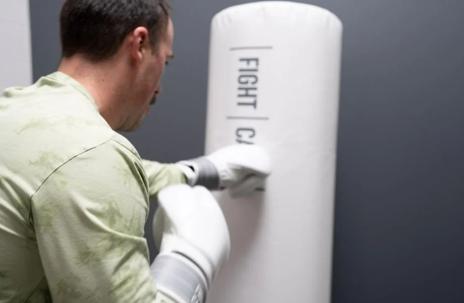 Coop lays into a FightCamp punching bag.
