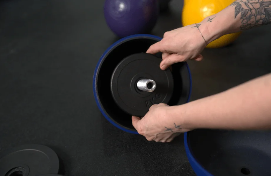 A cast change plate being centered in the Bells of Steel Adjustable Competition Style Kettlebell
