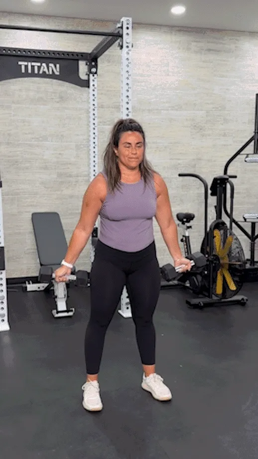 Woman doing a standing dumbbell fly
