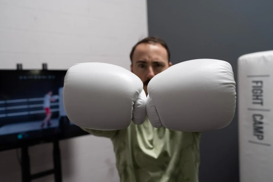 Coop poses with boxing gloves.