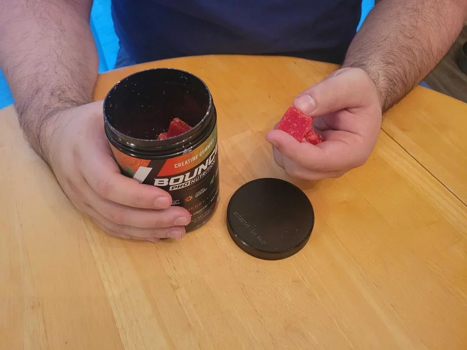 Caine Wilkes holding Bounce Nutrition Gummies.