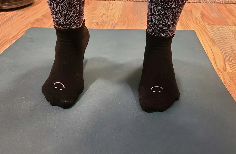 wearing pointe studio pilates socks on yoga mat