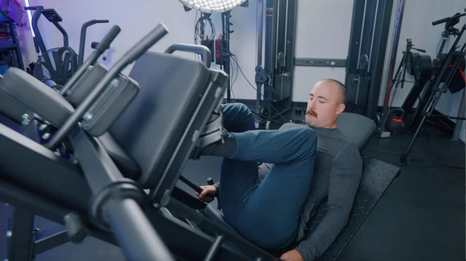 Coop performing leg presses on the Titan Leg Press Hack Squat Machine