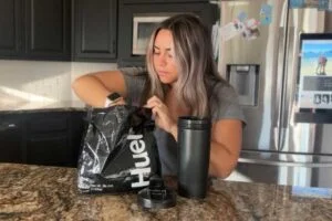 woman scooping huel black