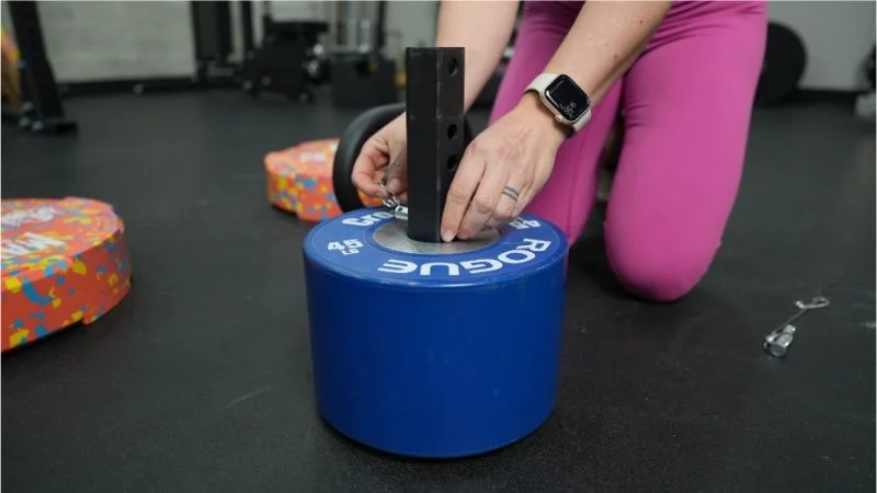 Adjusting the pin on the Titan Fitness Plate Loadable Kettlebell Swing