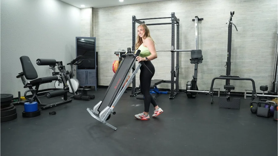 sunny health and fitness manual treadmill moving treadmill smiling at camera