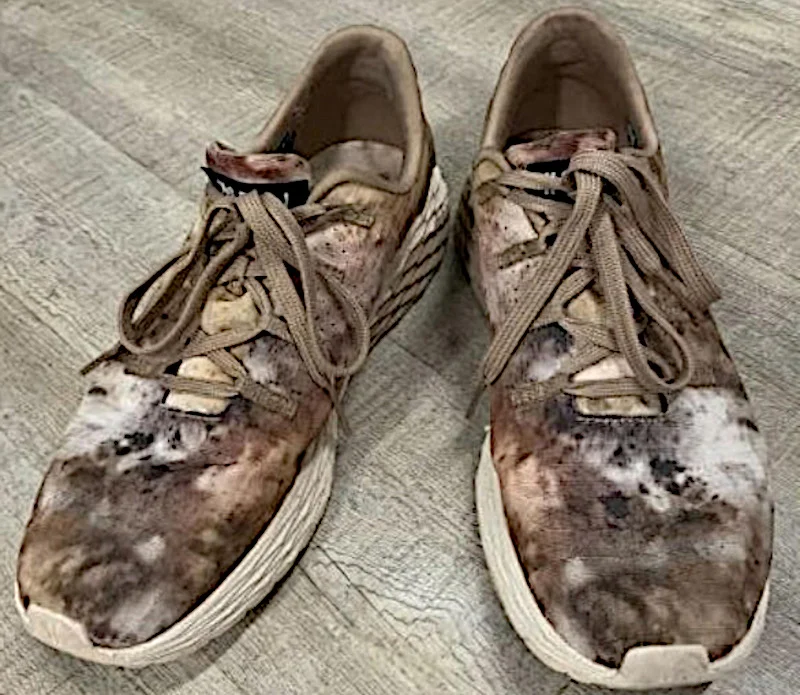 Looking down at a pair of NOBULL multicolored shoes.