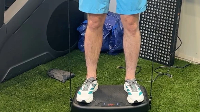 A person testing out a SoftGym Vibration Plate