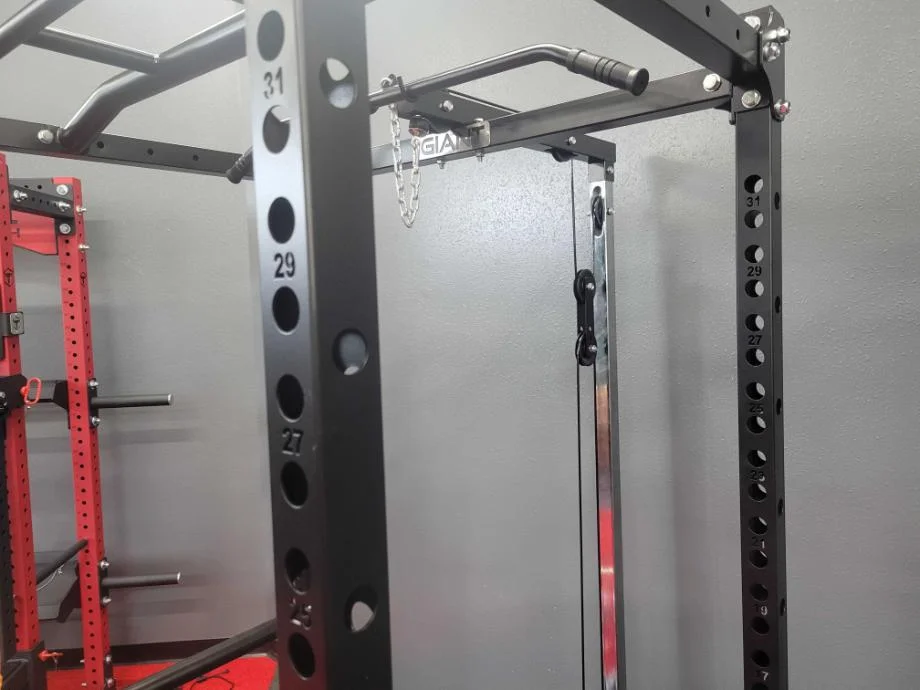 a close look at the steel on a giant lifting garage gym power rack with lat low row