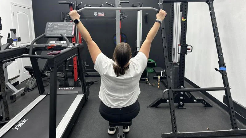 Our tester using the GDLF Lat Pulldown Machine