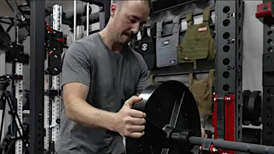 Coop puts a weight plate on the Rogue Ohio Barbell