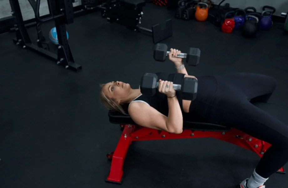 Our tester training with dumbbells atop the Major Fitness Adjustable Bench