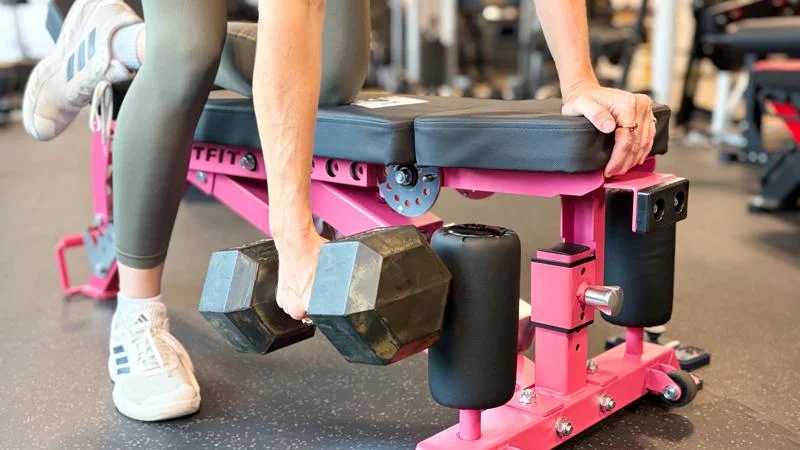 A person lifting weights on Ritfit Gator Bench.