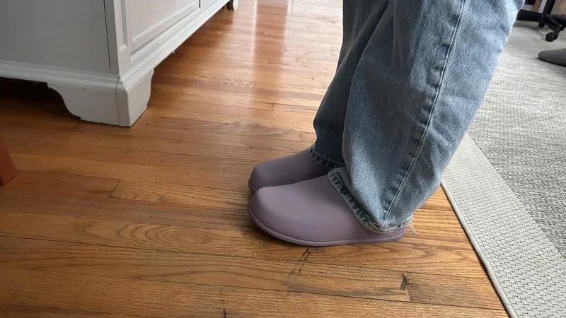 Side view of a person wearing Lululemon SwayDay Mule recovery shoes.