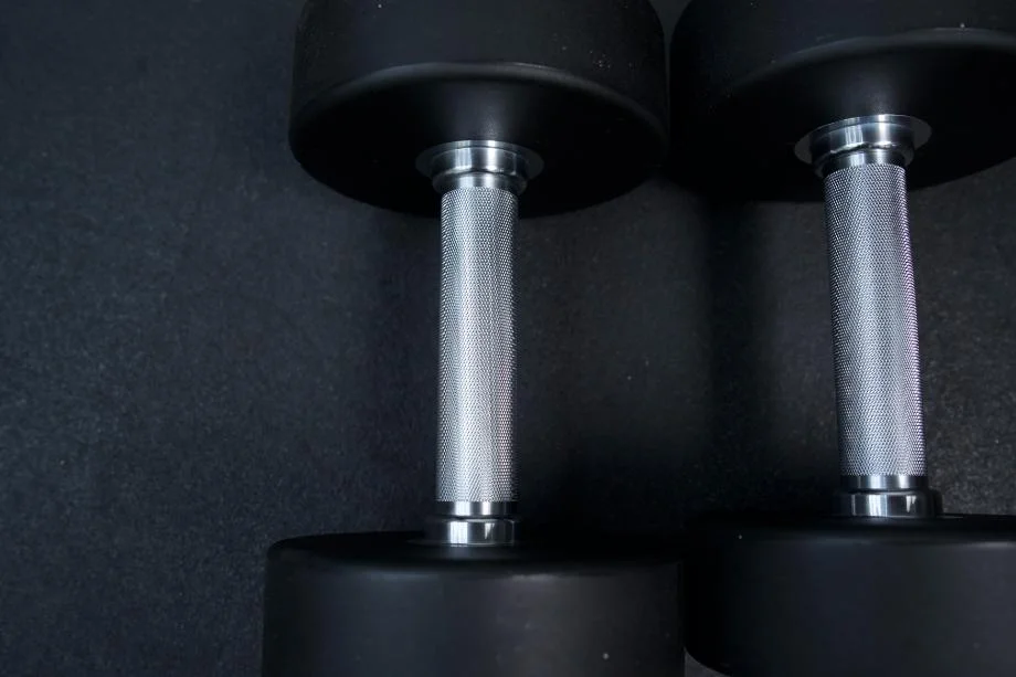 A close look at the knurling on a pair of Rogue Urethane Dumbbells.