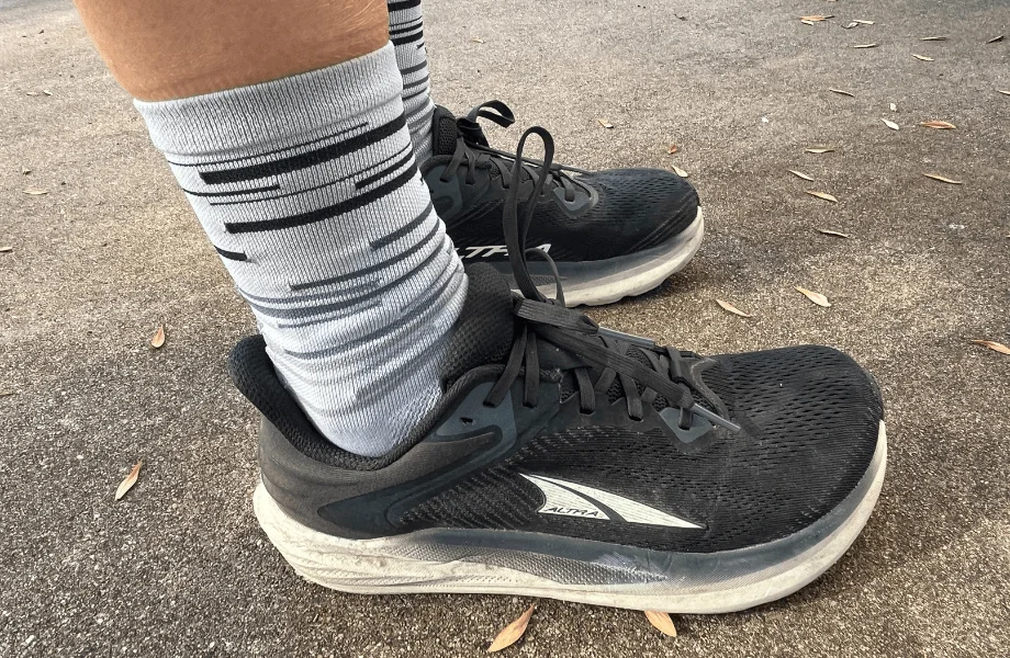 Our tester showing off the upper design of the Altra Torin 8 running shoes