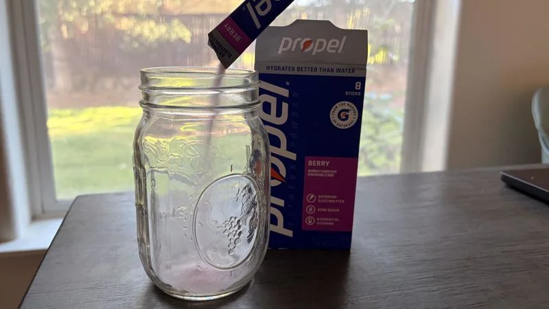 Our tester pours a Propel Hydration Mix Packet into a pint-sized mason jar