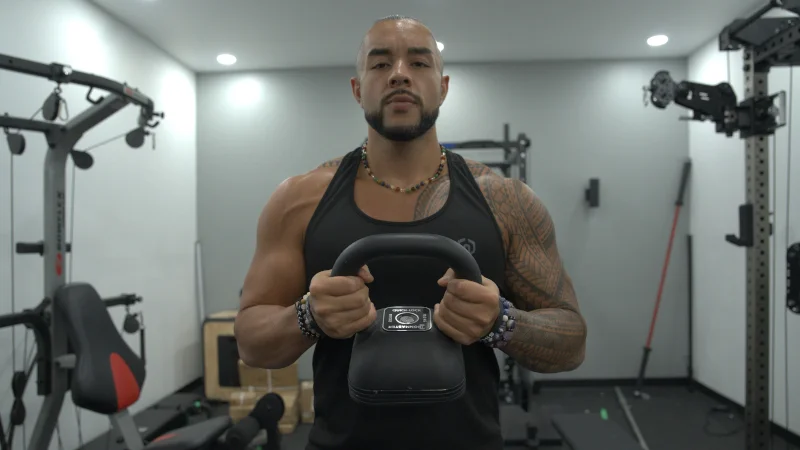 Stephen SHeehan, CPT, CNC, takes a meditative stance with a kettlebell