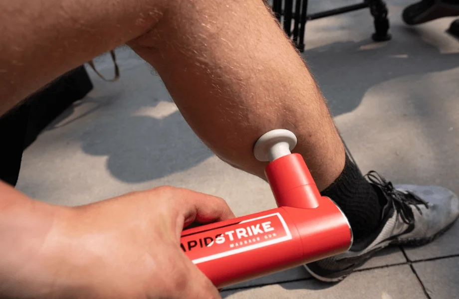 Our tester massaging their calf with the REP Rapidstrike Massage Gun