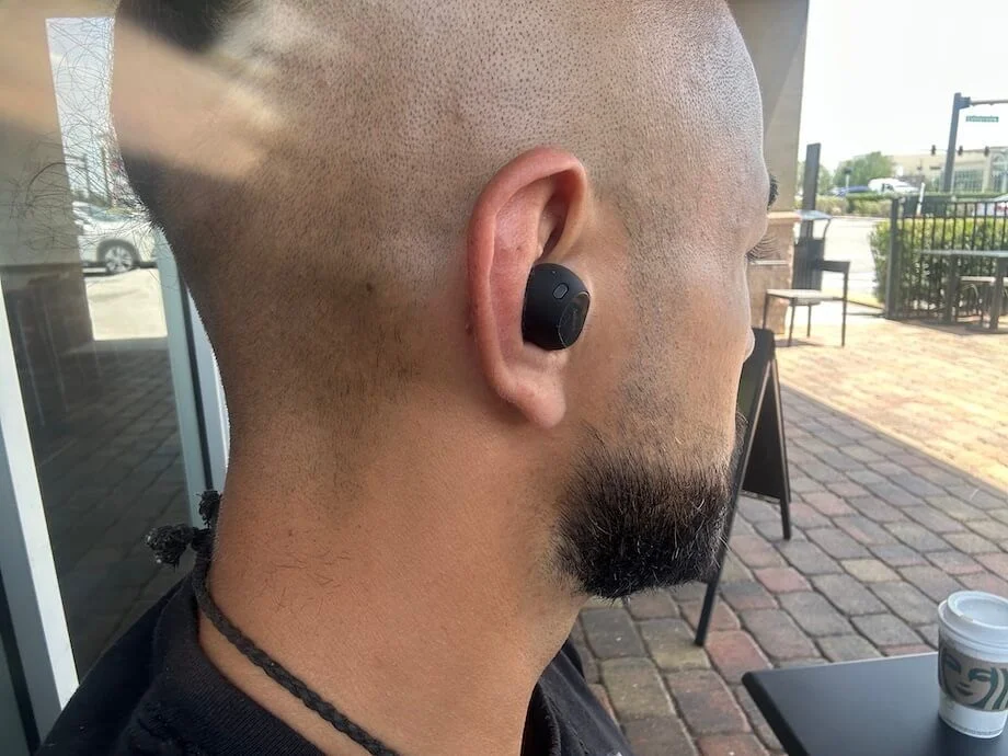 Our tester wearing Jabra Elite 10 wireless earbuds.