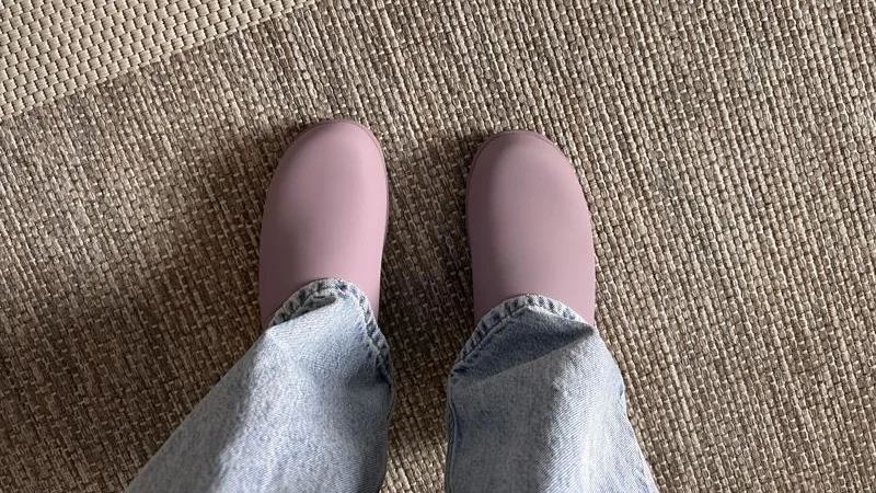 Looking down at a pair of Lululemon SwayDay Mule recovery shoes.