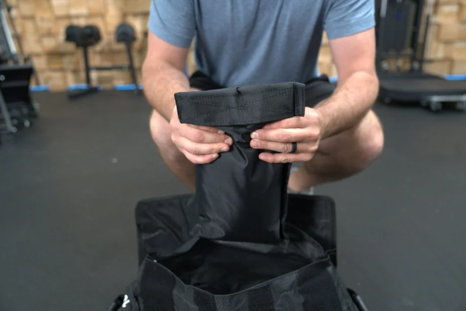 Aperson holds the internal sandbags from a Centr x HYROX Competition Sand Bag