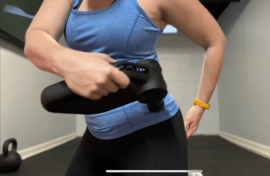 Our tester using the Bob and Brad D6 Pro massage gun