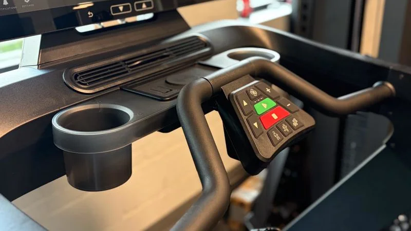 A close look at the cupholders, fan, and control console on the Aviron Podium Treadmill