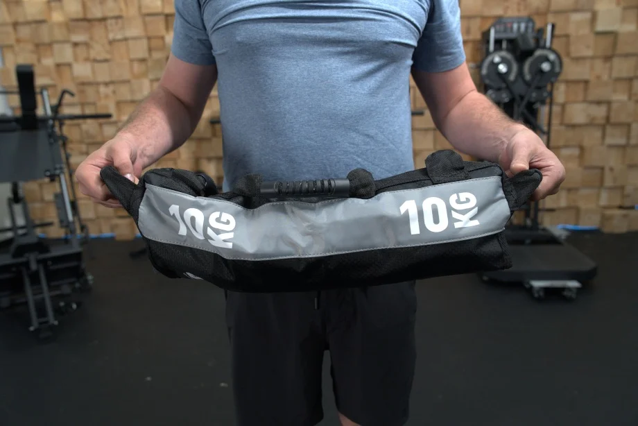 Our tester holds up a Centr x HYROX Competition Sand Bag