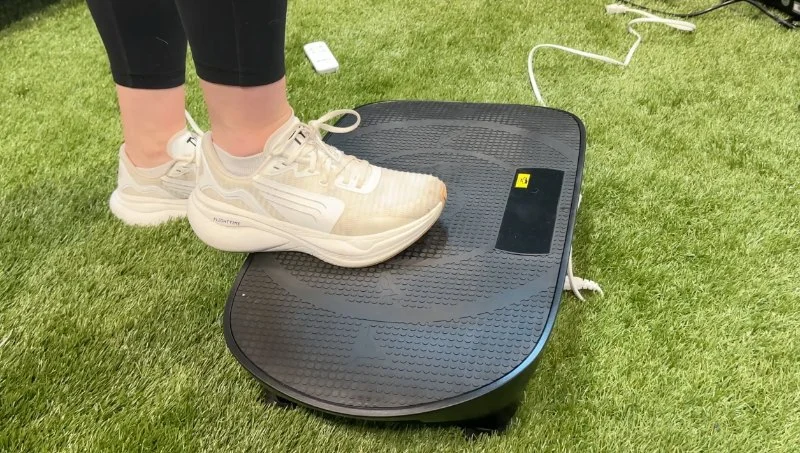 Our tester steps onto a Merach CV30 Pro Vibration Plate