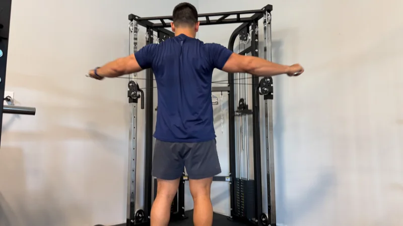Our tester demonstrating the cable function on the Bells of Steel Functional Trainer