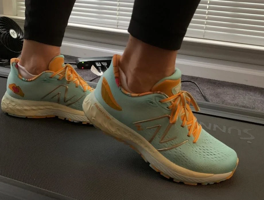 A person poses in a pair of New Balance Fresh Foam 880 shoes