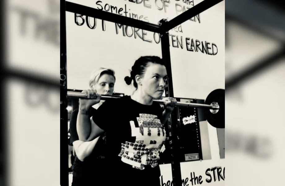 Female coach spotting squat