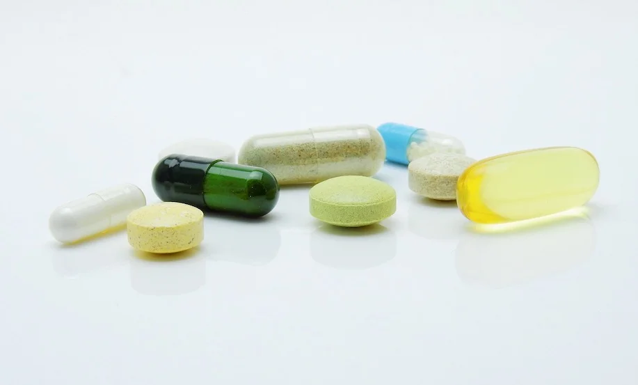 An assortment of scattered pills and capsules to represent the best biohacking supplements