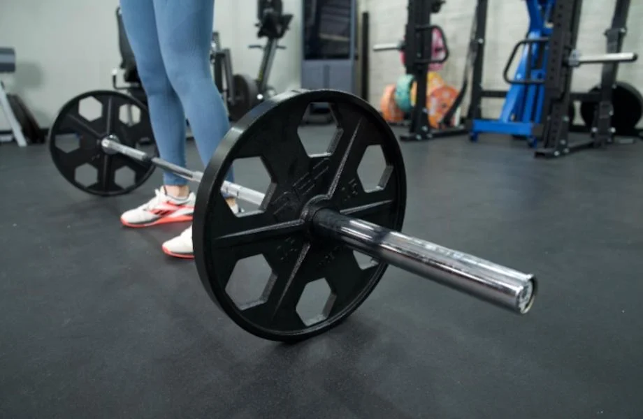 A Major Fitness Barbell at a person's feet