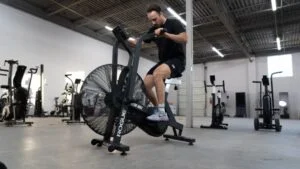 man_riding_rogue_echo_bike_in_home_gym